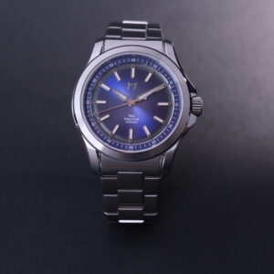 Close-up of a stainless steel wristwatch with a blue dial.