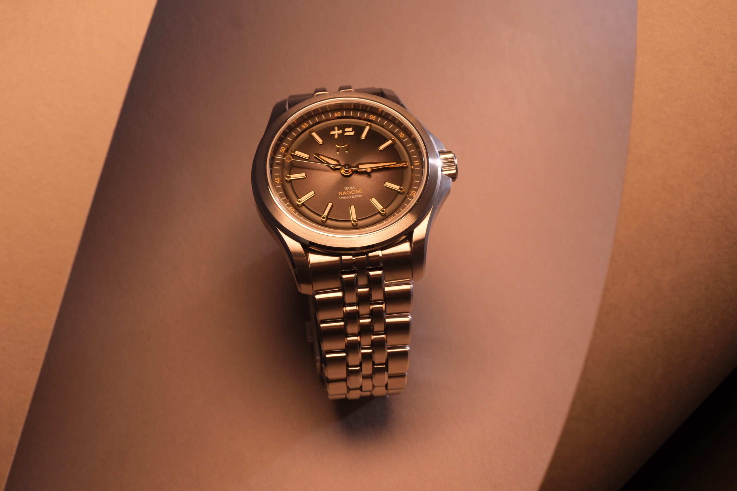 Elegant gold wristwatch with a textured dial and metal bracelet.