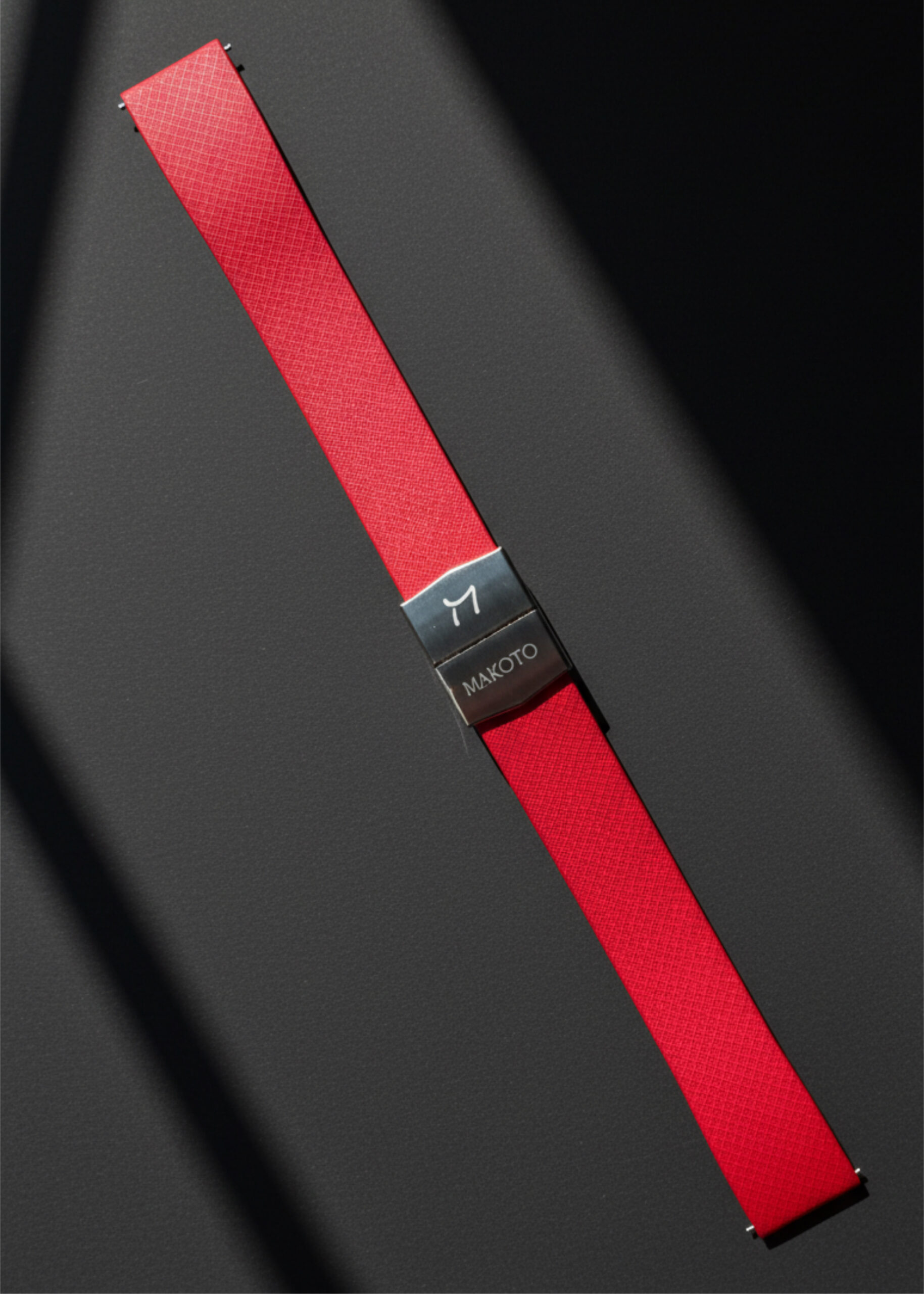 Close-up of a red seatbelt with a black buckle in a car.