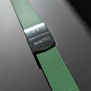 Green watch strap with Maxxto branding on the clasp.